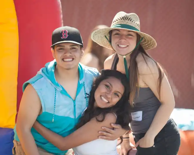 Three girls smiling at the camera
